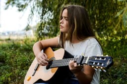 Musician with an acoustic guitar on stage
